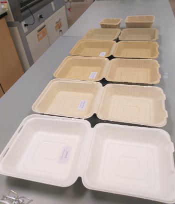 Cardboard food package containers lined up on a table